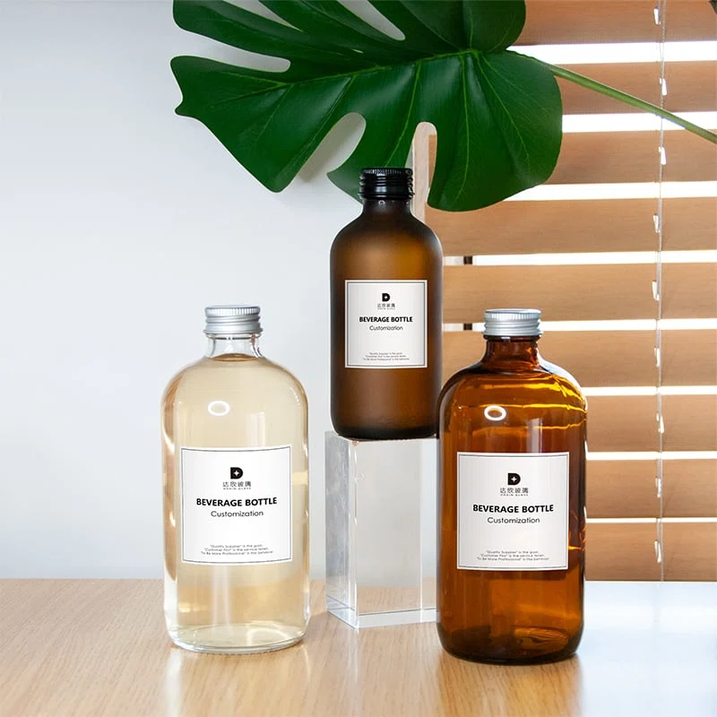 three flexible custom glass bottle packaging for beverages with screwed on closure 01