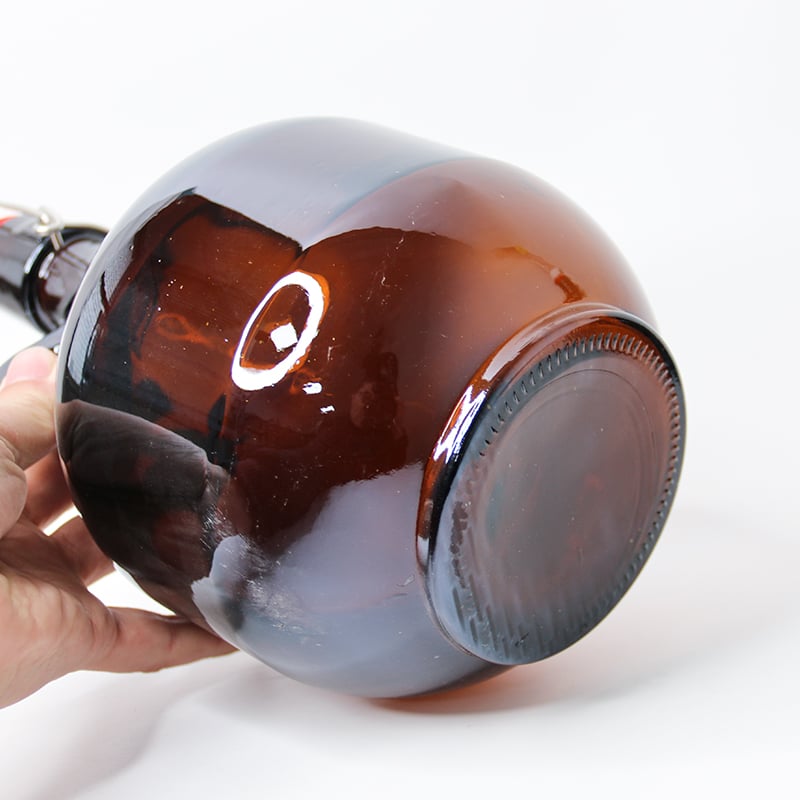 bottom of a glass jug packaging for beverages with stopper closure 01