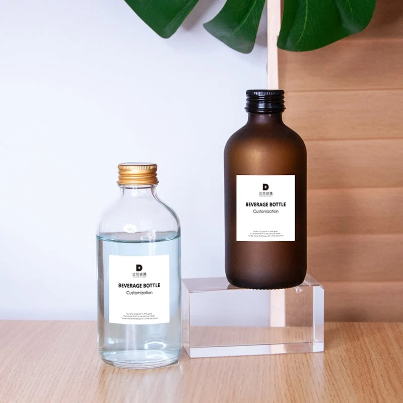 two flexible custom glass bottle packaging for beverages with screwed on closure 01